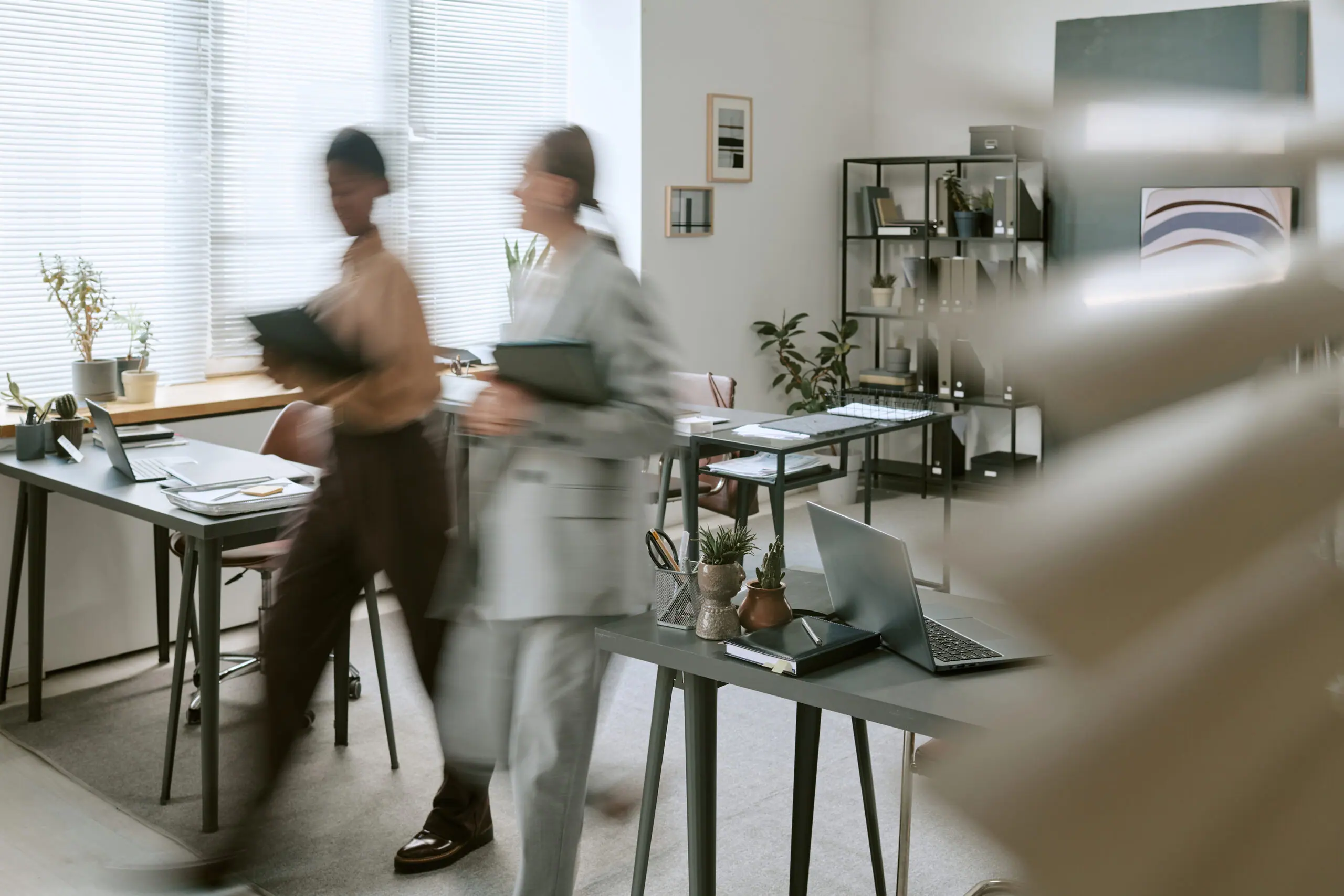 Colleagues walking through a bright, modern office